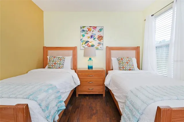 a bedroom with two beds and a window