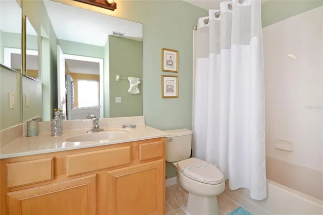 a living room with furniture a flat screen tv and a window