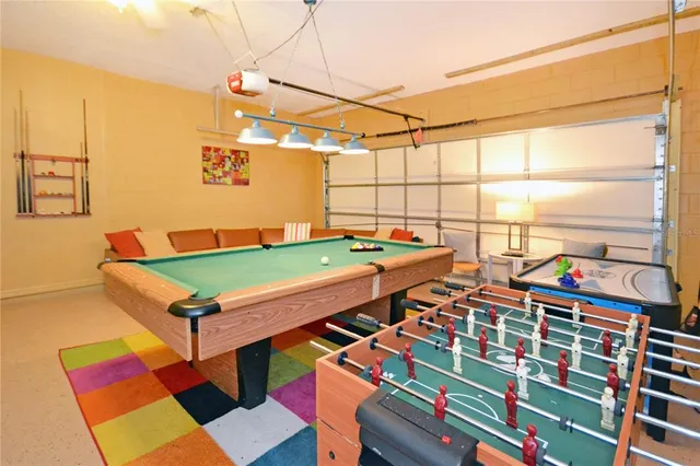 a view of a dining room with furniture water view and a floor to ceiling window