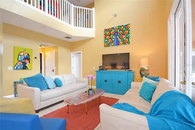 a kitchen with stainless steel appliances granite countertop a sink a stove a refrigerator a dining table and chairs