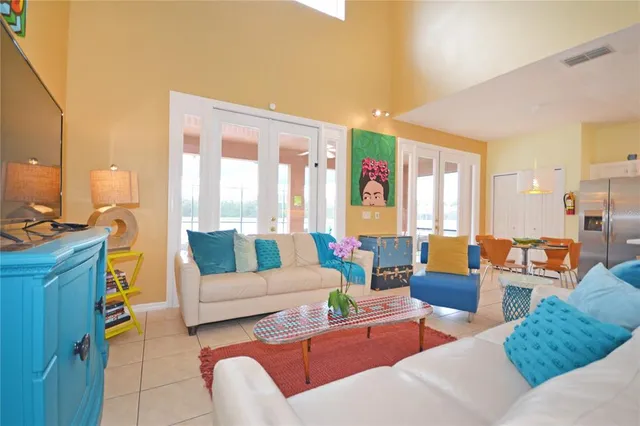 a kitchen with stainless steel appliances granite countertop a table chairs sink and cabinets