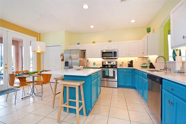 a kitchen with a sink a microwave and wooden cabinets