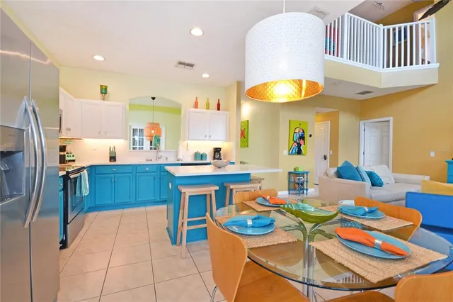a view of a dining room with furniture and a chandelier