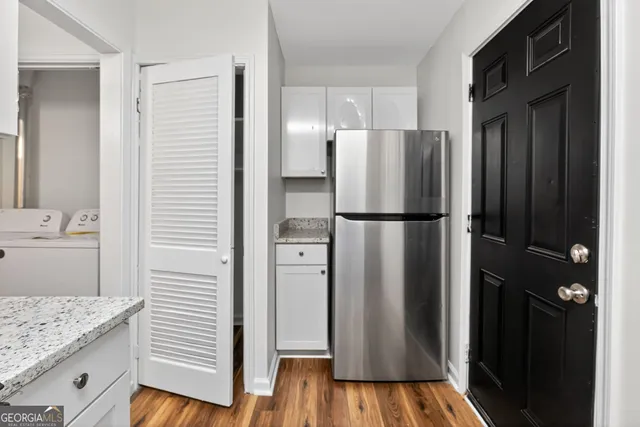 a kitchen with stainless steel appliances granite countertop a refrigerator and a sink