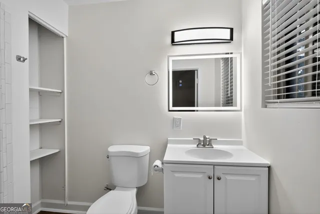 a bathroom with a sink toilet and vanity