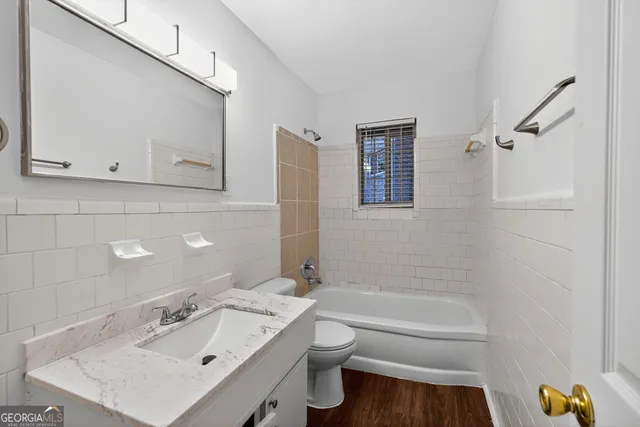 a bathroom with a sink a toilet and bathtub