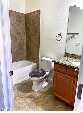 a kitchen with stainless steel appliances granite countertop a sink a stove and refrigerator