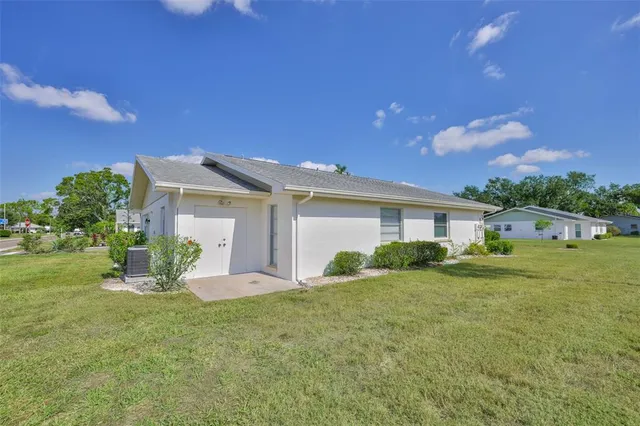 a backyard of a house with table and chairs