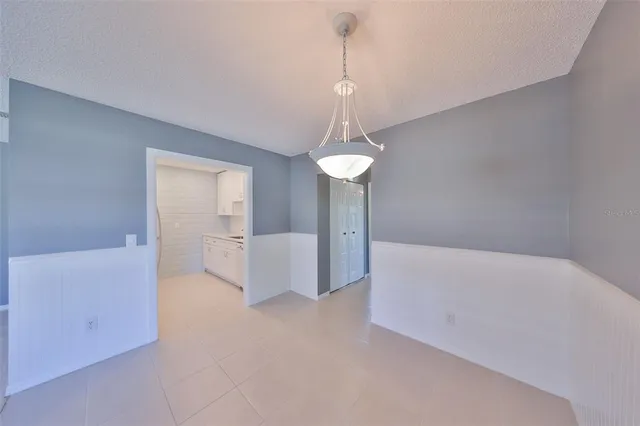 a view of a room with cabinet and chandelier
