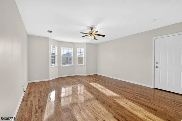 wooden floor in a room next to a window