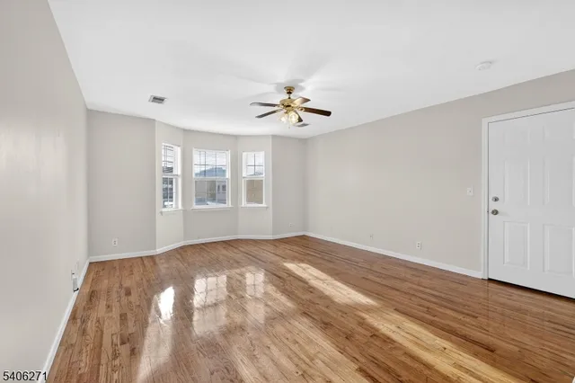 wooden floor in a room next to a window
