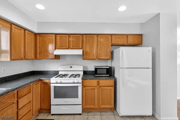 a kitchen with a refrigerator sink and stove