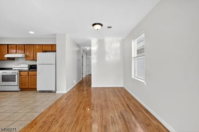 a view of kitchen with wooden floor electronic appliances and window