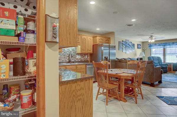 a dining room with furniture and a kitchen view