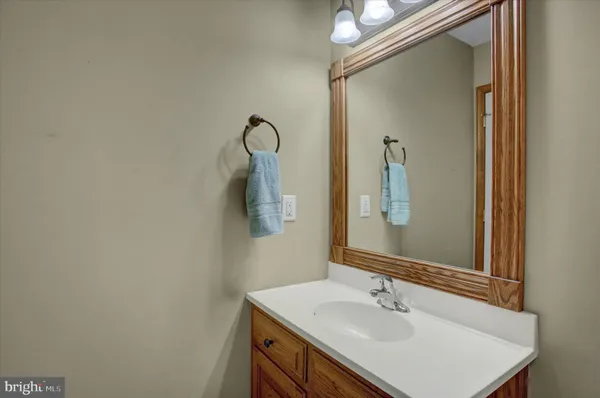 a bathroom with a sink a mirror and a vanity