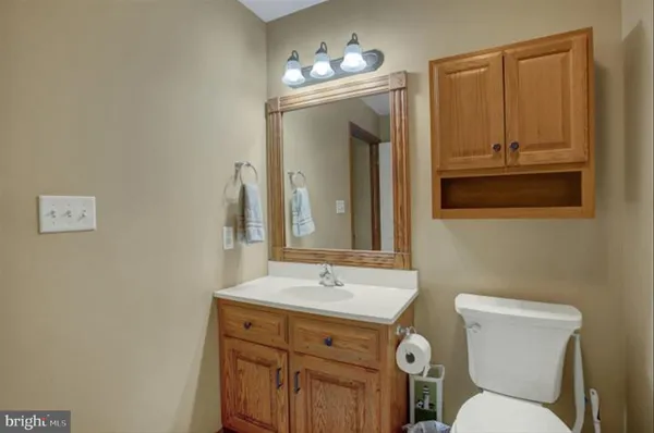 a bathroom with a toilet sink and mirror