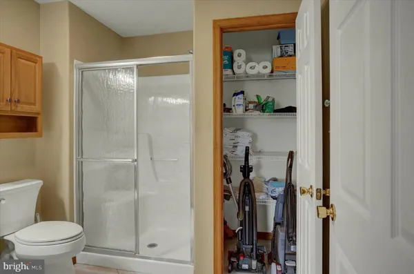 a bathroom with a shower a toilet and a sink