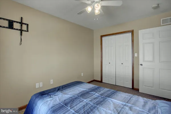 a view of a room with a ceiling fan
