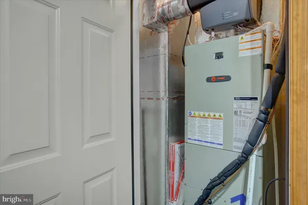 a close up of a storage & utility room with a refrigerator