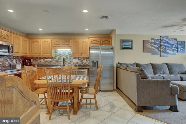 a dining room with furniture and a kitchen view