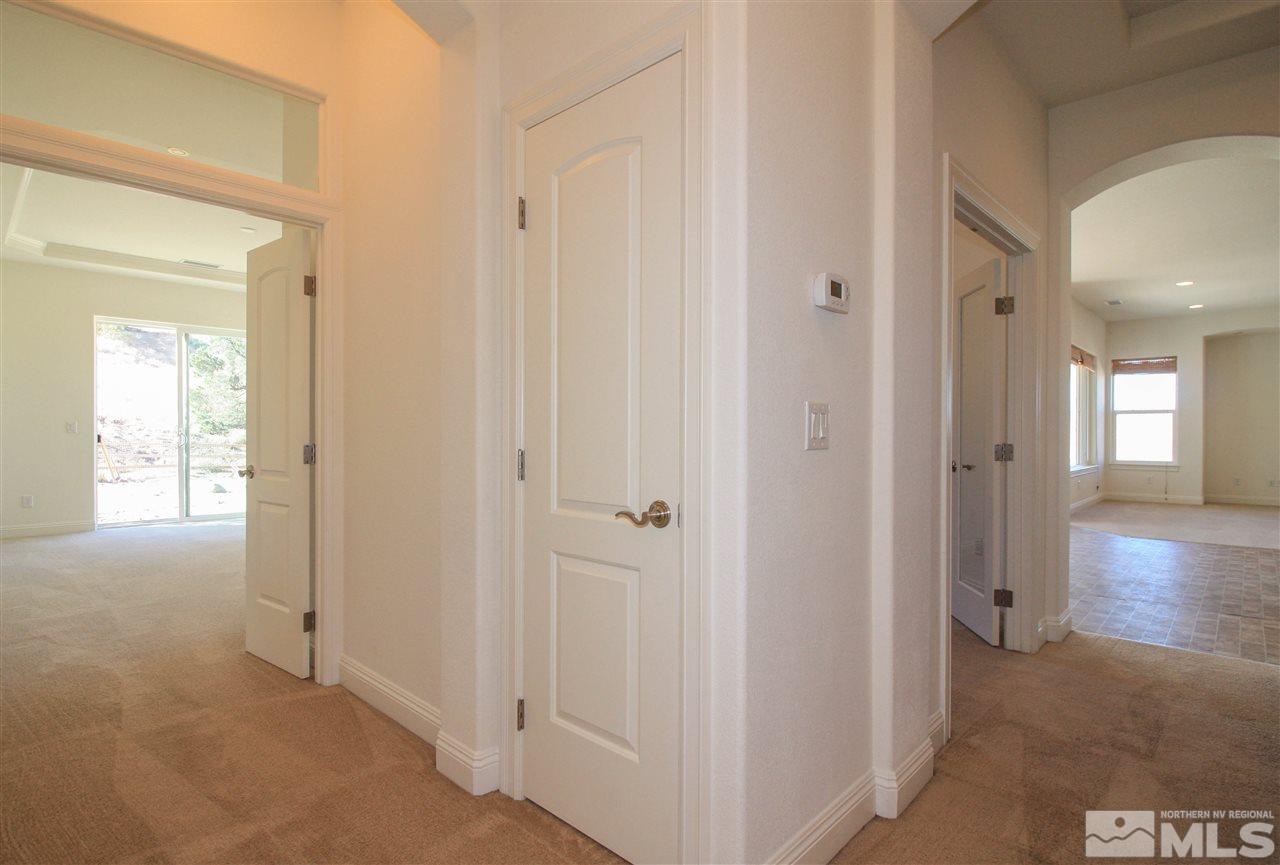 7505 Rough Rock Drive Reno, NV 89502 - Photo 17 of 25 a view of a hallway with wooden floor