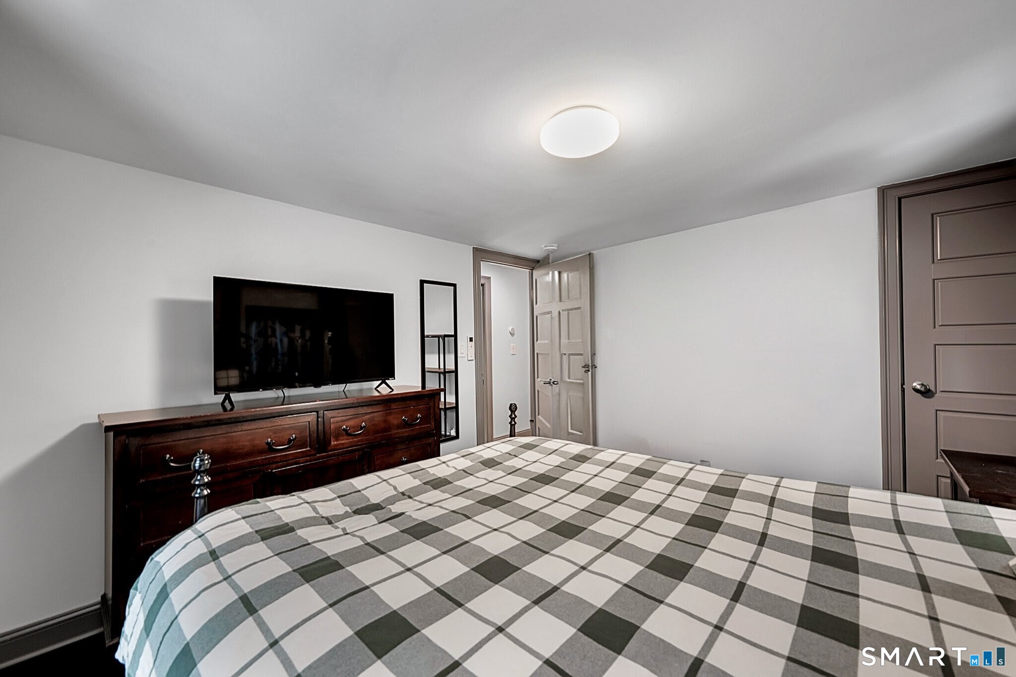 219 Prospect Avenue Meriden, CT 06451 - Photo 18 of 30 a bedroom with a bed and a flat screen tv