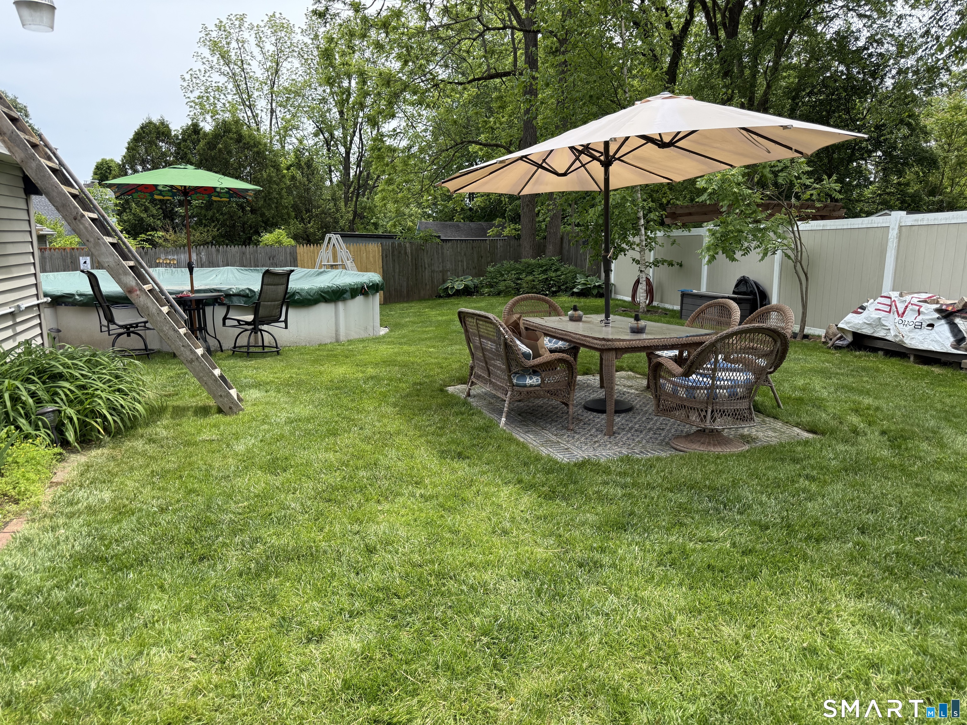 219 Prospect Avenue Meriden, CT 06451 - Photo 26 of 30 a view of a table and chairs under an umbrella