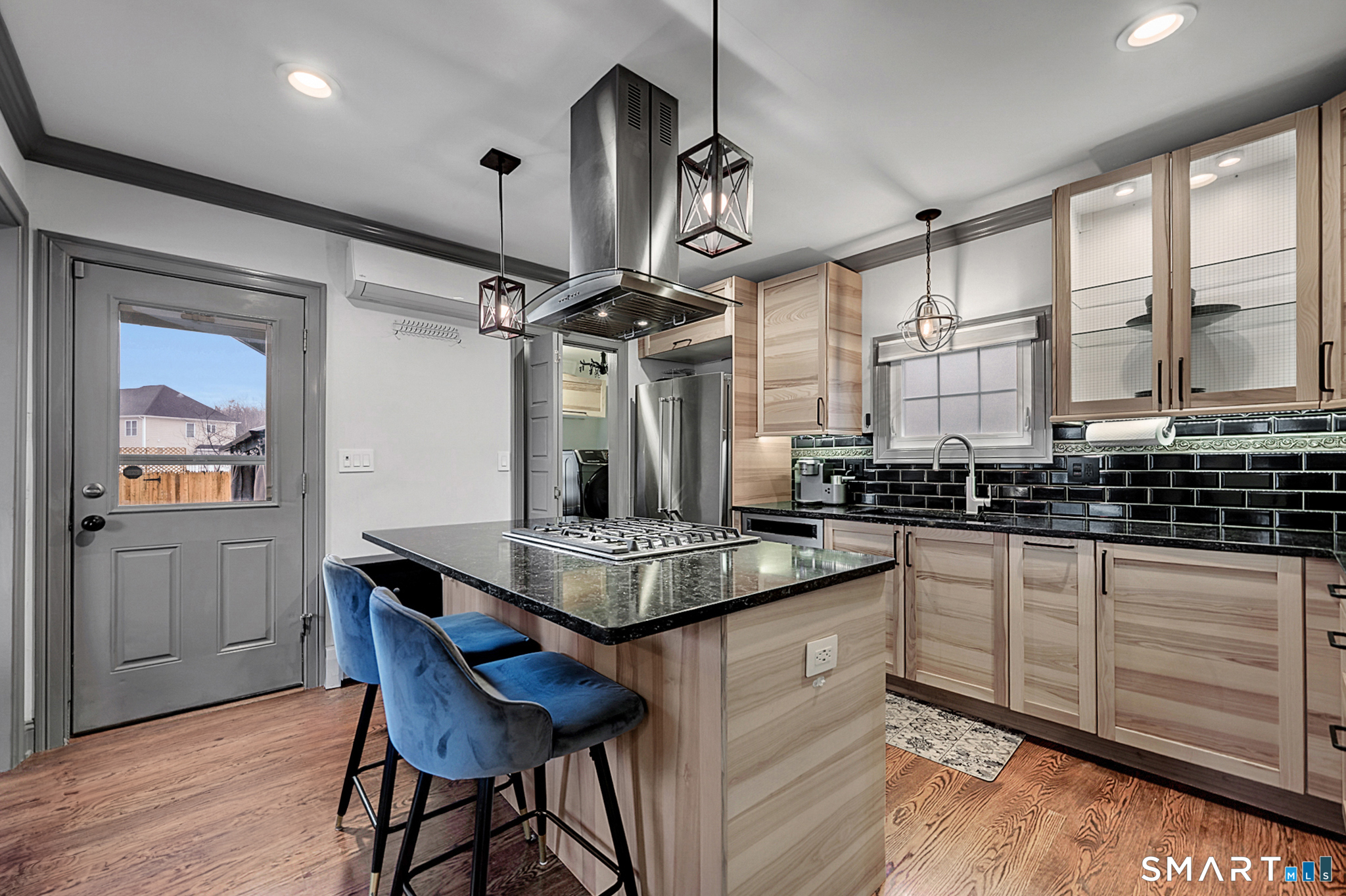 219 Prospect Avenue Meriden, CT 06451 - Photo 5 of 30 a kitchen with stainless steel appliances kitchen island granite countertop a table chairs and wooden cabinets