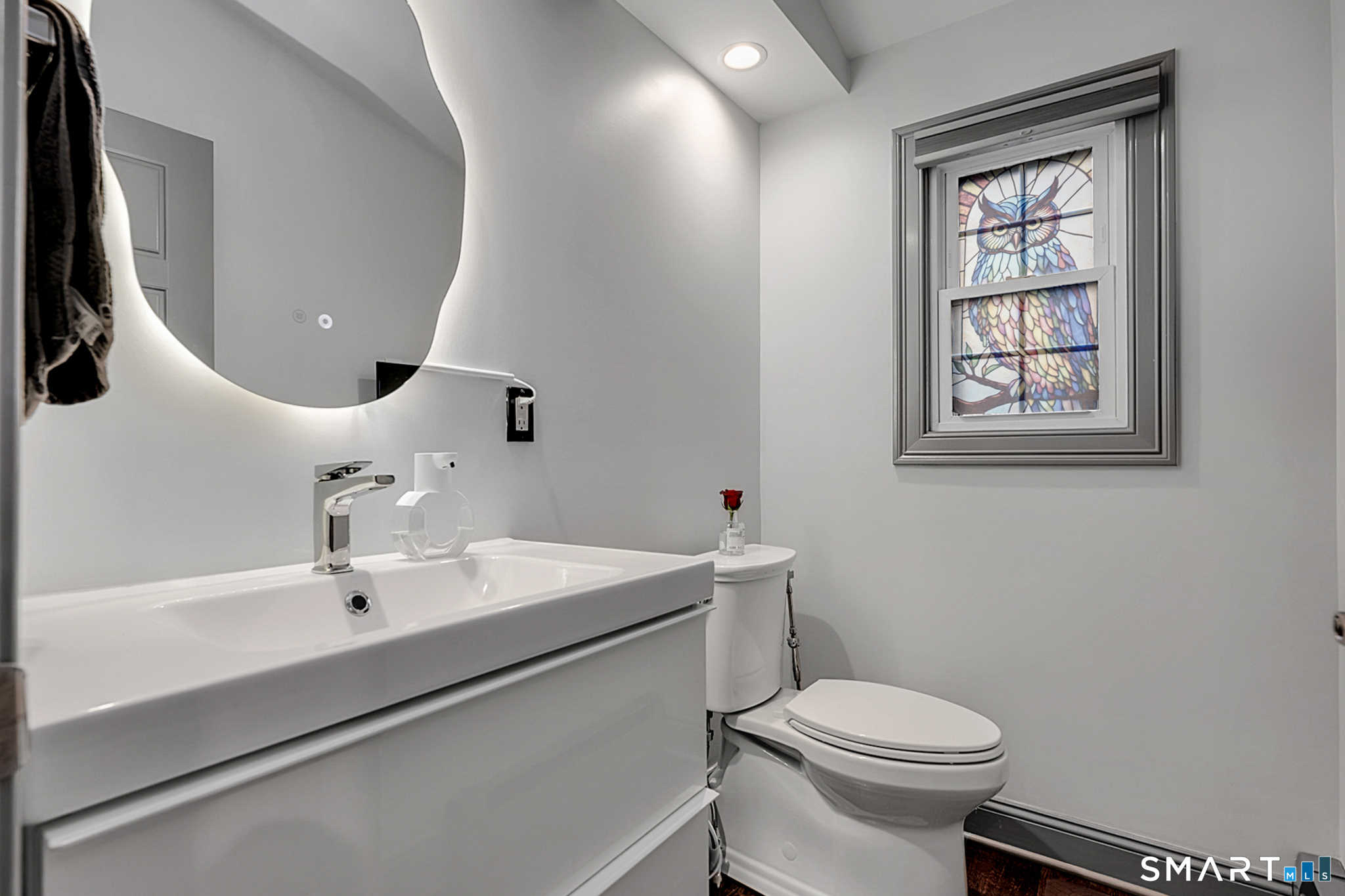 219 Prospect Avenue Meriden, CT 06451 - Photo 9 of 30 a bathroom with a sink a toilet and mirror