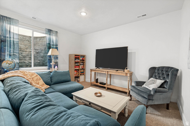 683 Kings Landing Tooele, UT 84074 - Photo 24 of 39 Spacious living area featuring white walls, recessed lighting, and neutral carpet flooring