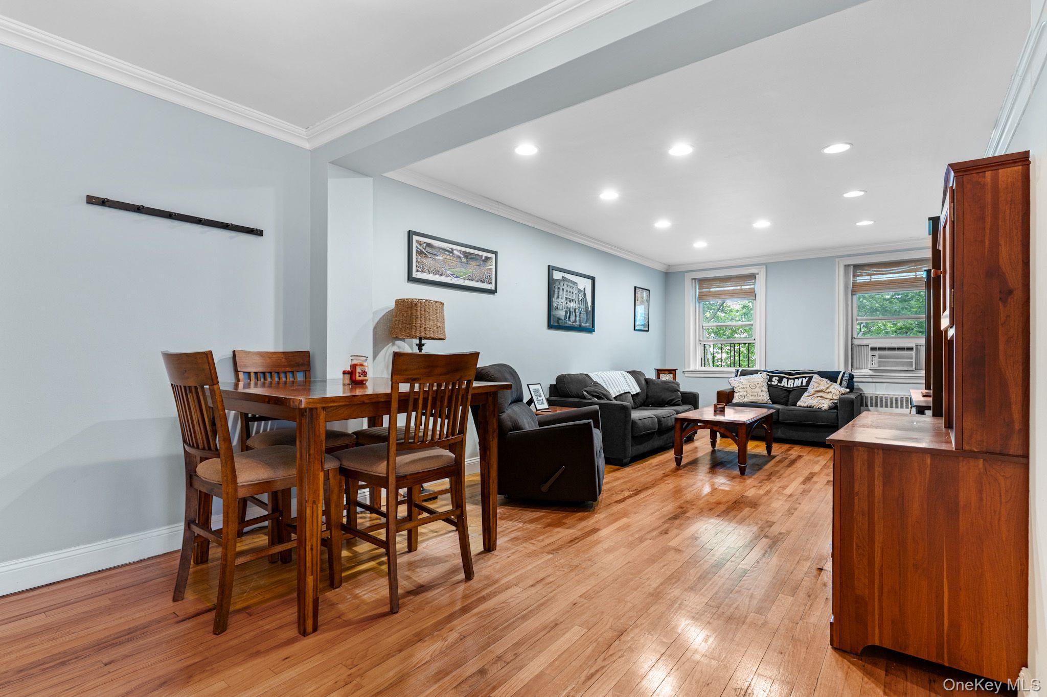 755 Bronx River Road, Unit 4B Bronxville, NY 10708 - Photo 4 of 27 Open-concept living space featuring wood-finish flooring, recessed lighting, crown molding, and multiple windows