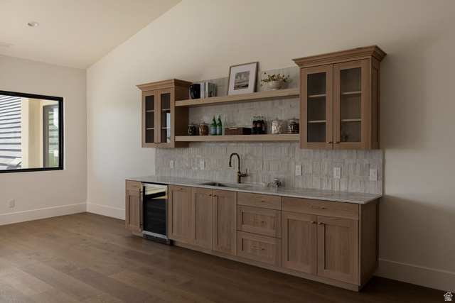 2281 South Crimson Cliffs Way St. George, UT 84790 - Photo 31 of 47 Indoor wet bar with glass fronted cabinets, backsplash, lofted ceiling, wine cooler, and light stone counters