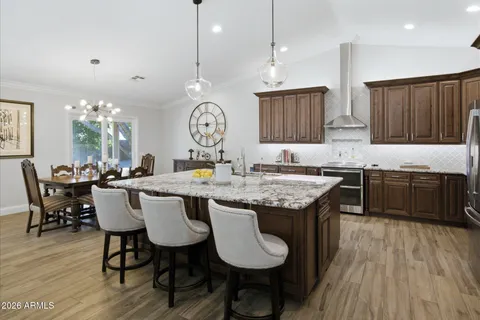 a large kitchen with a table and chairs