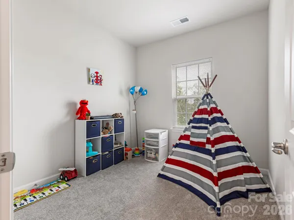 a bedroom with stairs and a couch