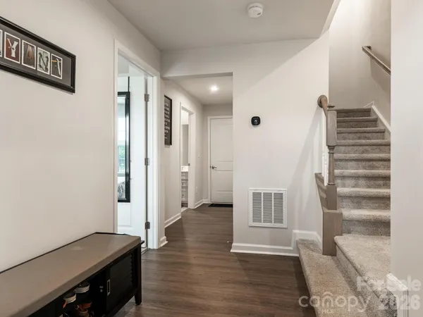 a view of a hallway with wooden floor and entryway