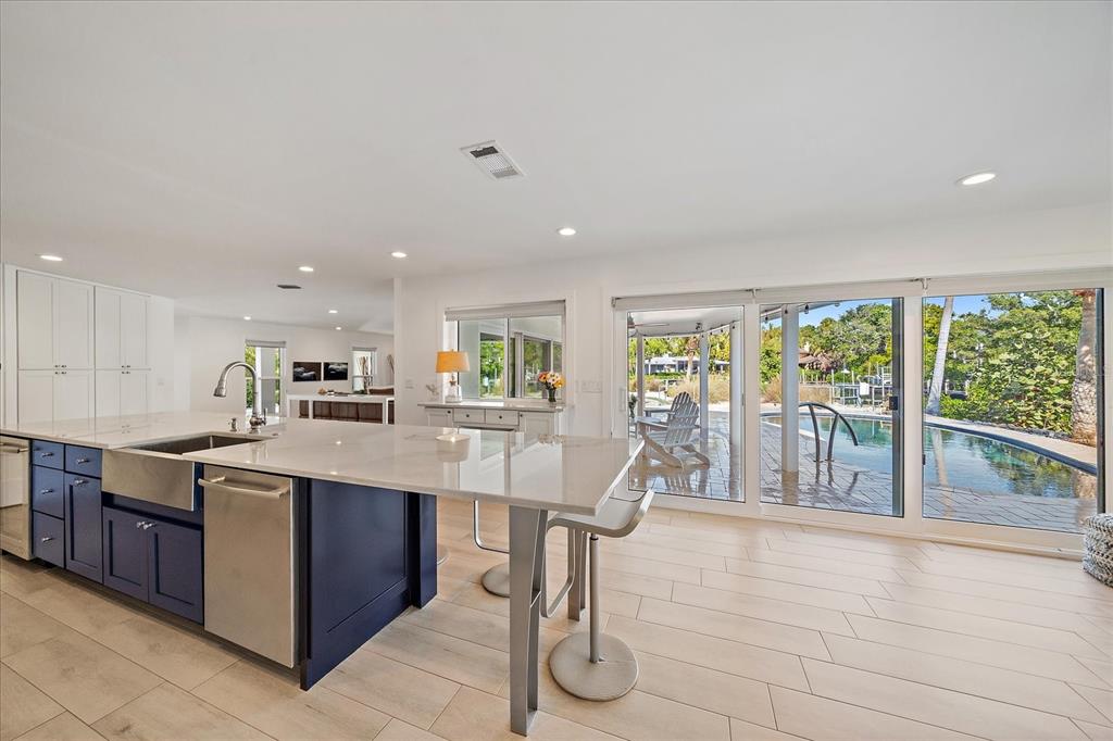 5155 Hidden Harbor Road Sarasota, FL 34242 - Photo 20 of 56 a open kitchen with stainless steel appliances granite countertop a refrigerator a sink a stove and white cabinets with wooden floor
