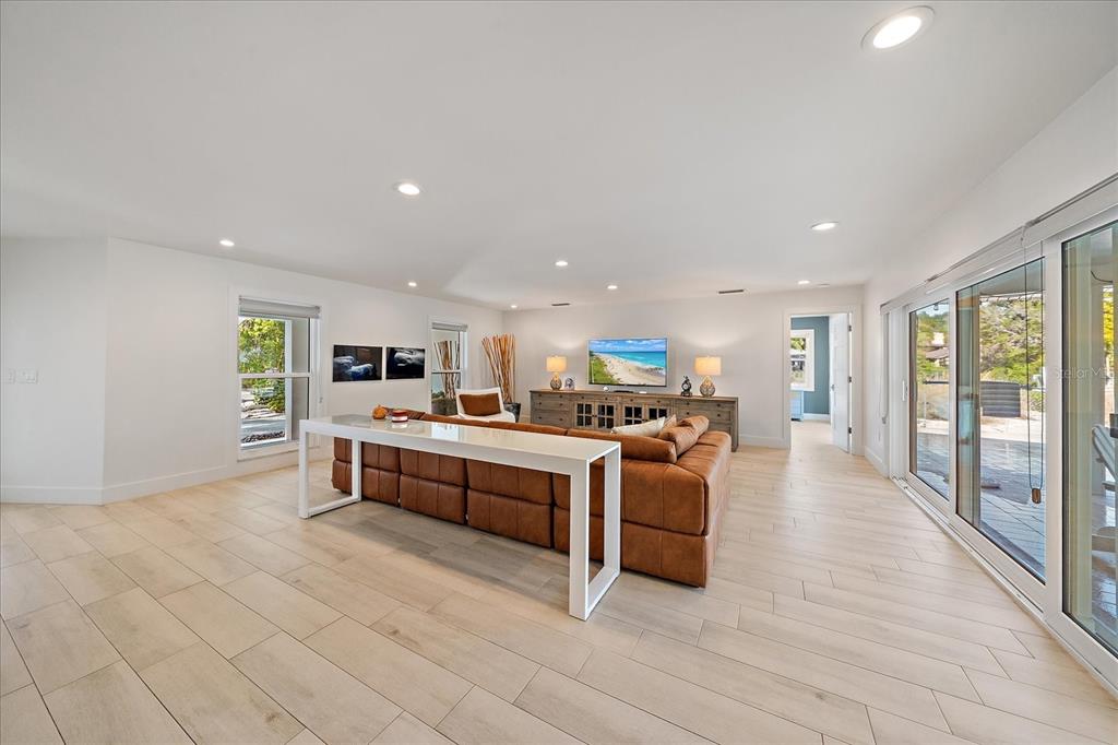 5155 Hidden Harbor Road Sarasota, FL 34242 - Photo 26 of 56 a view of living room with kitchen island stainless steel appliances wooden floor and window