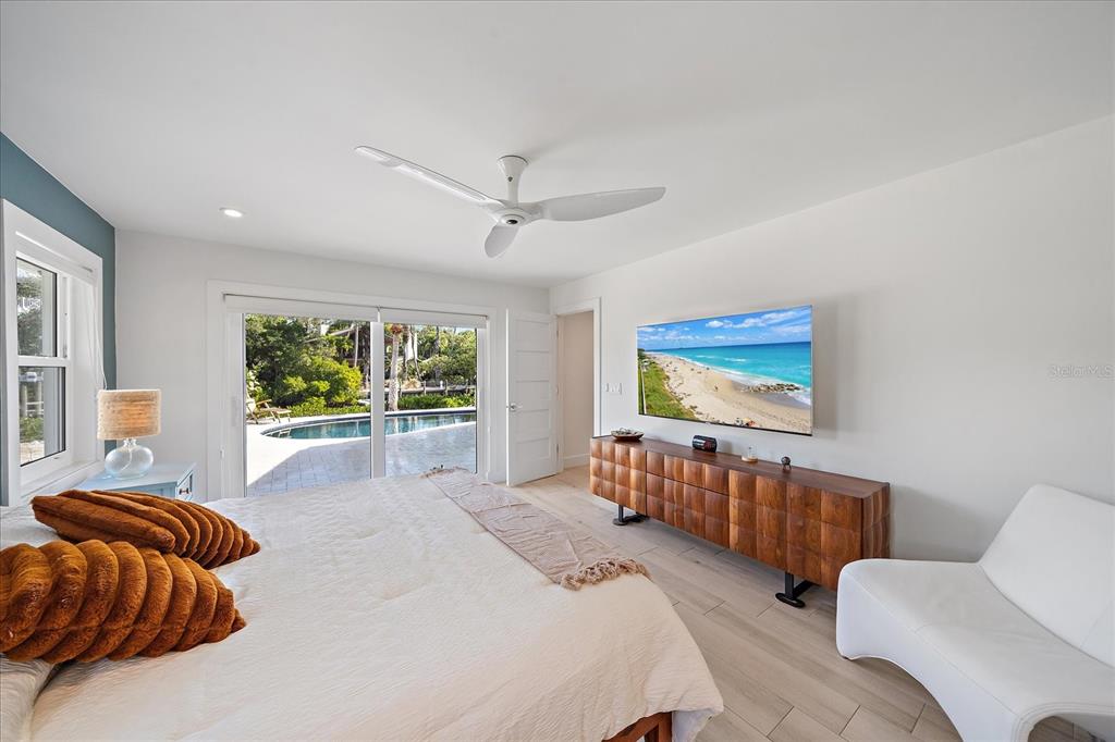 5155 Hidden Harbor Road Sarasota, FL 34242 - Photo 30 of 56 a bedroom with furniture and a large window