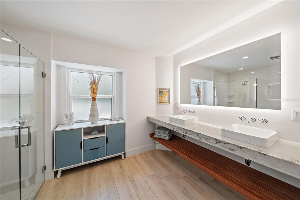 5155 Hidden Harbor Road Sarasota, FL 34242 - Photo 31 of 56 a bathroom with a double vanity sink and mirror