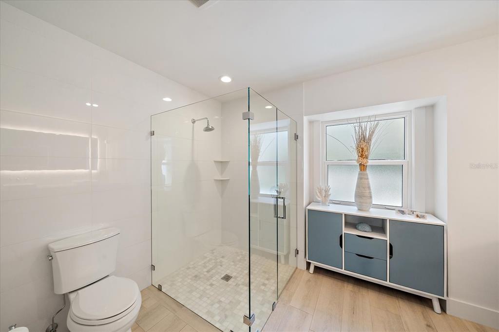 5155 Hidden Harbor Road Sarasota, FL 34242 - Photo 32 of 56 a bathroom with a toilet a sink and shower