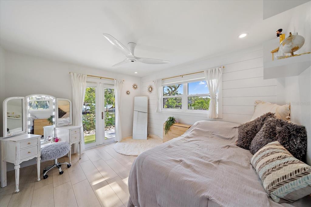 5155 Hidden Harbor Road Sarasota, FL 34242 - Photo 33 of 56 a bedroom with a bed and large windows
