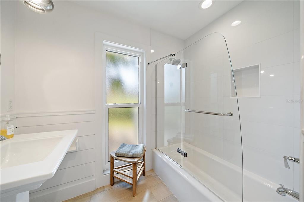 5155 Hidden Harbor Road Sarasota, FL 34242 - Photo 40 of 56 a bathroom with a bathtub and a shower