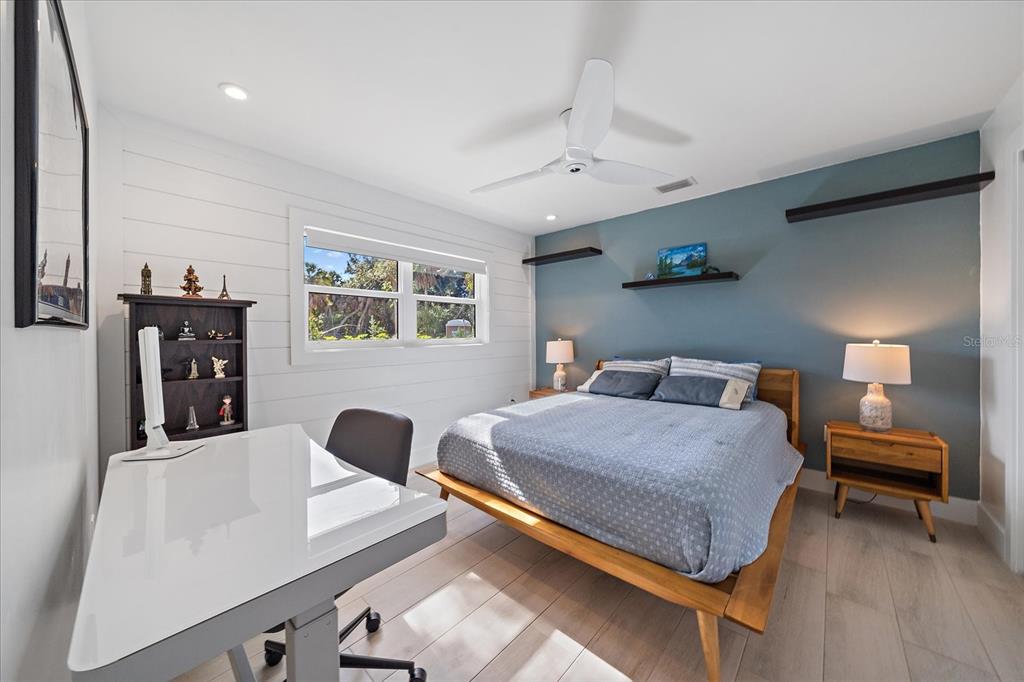 5155 Hidden Harbor Road Sarasota, FL 34242 - Photo 41 of 56 a bedroom with a bed and a couch