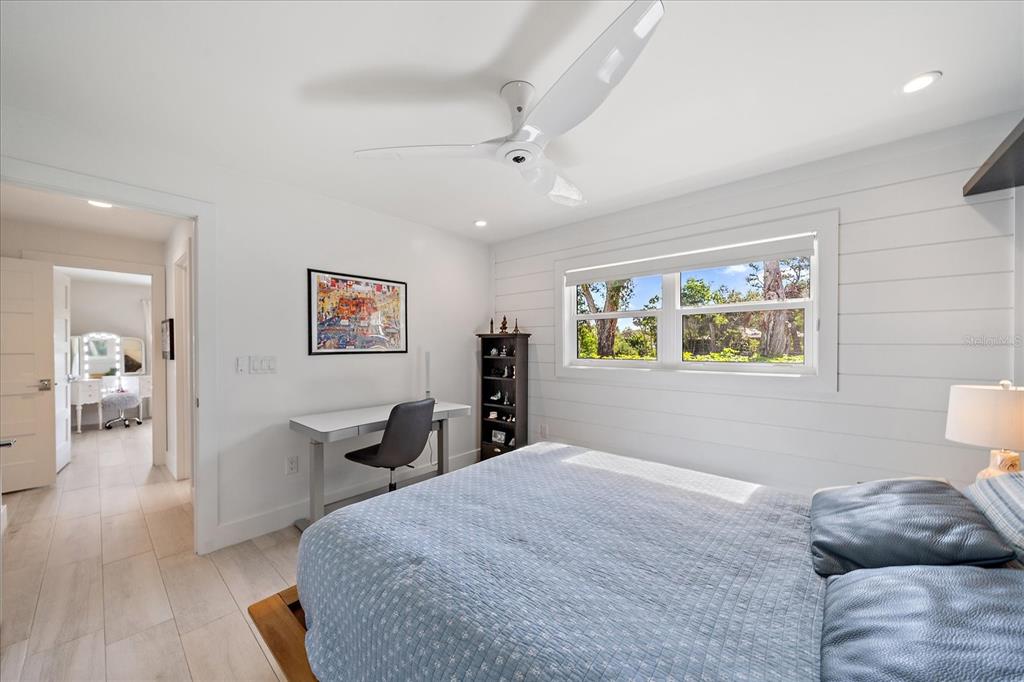 5155 Hidden Harbor Road Sarasota, FL 34242 - Photo 43 of 56 a bedroom with a bed and wooden floor