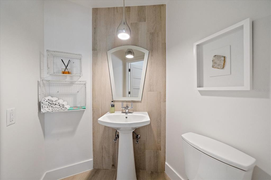 5155 Hidden Harbor Road Sarasota, FL 34242 - Photo 44 of 56 a bathroom with a toilet sink and mirror