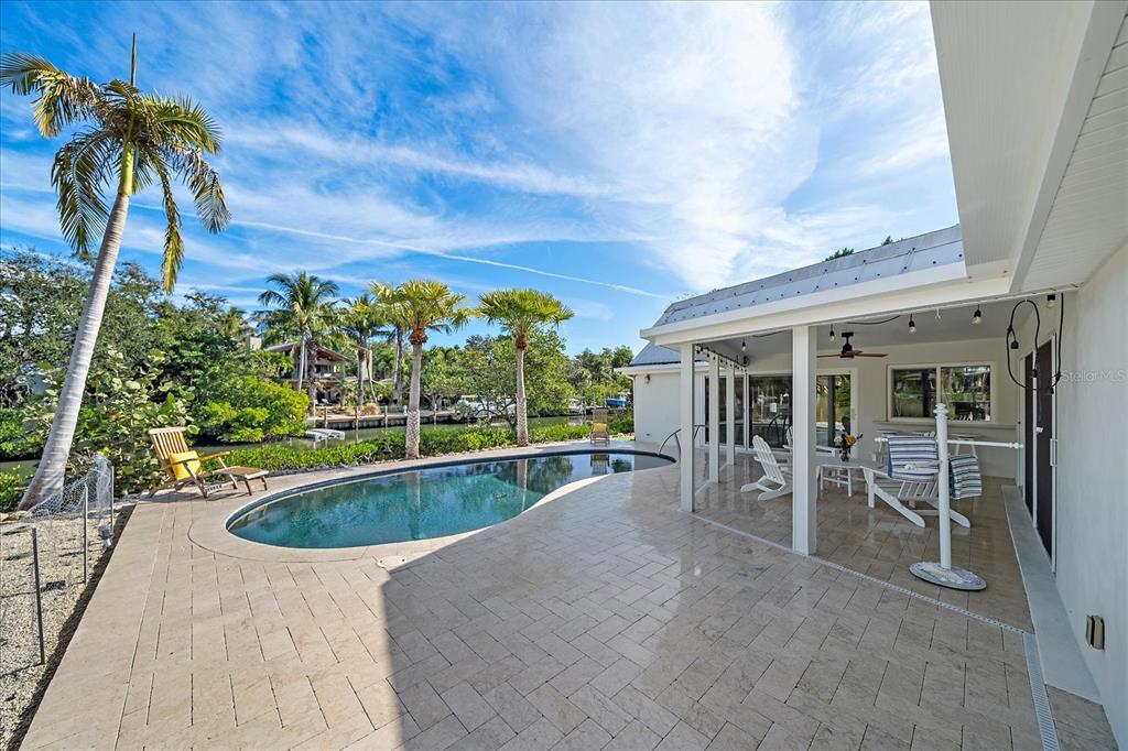 5155 Hidden Harbor Road Sarasota, FL 34242 - Photo 53 of 56 a view of a swimming pool with a patio and a garden