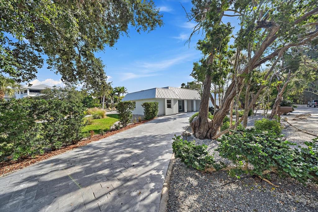 5155 Hidden Harbor Road Sarasota, FL 34242 - Photo 10 of 56 a front view of a house with a yard and shrubs