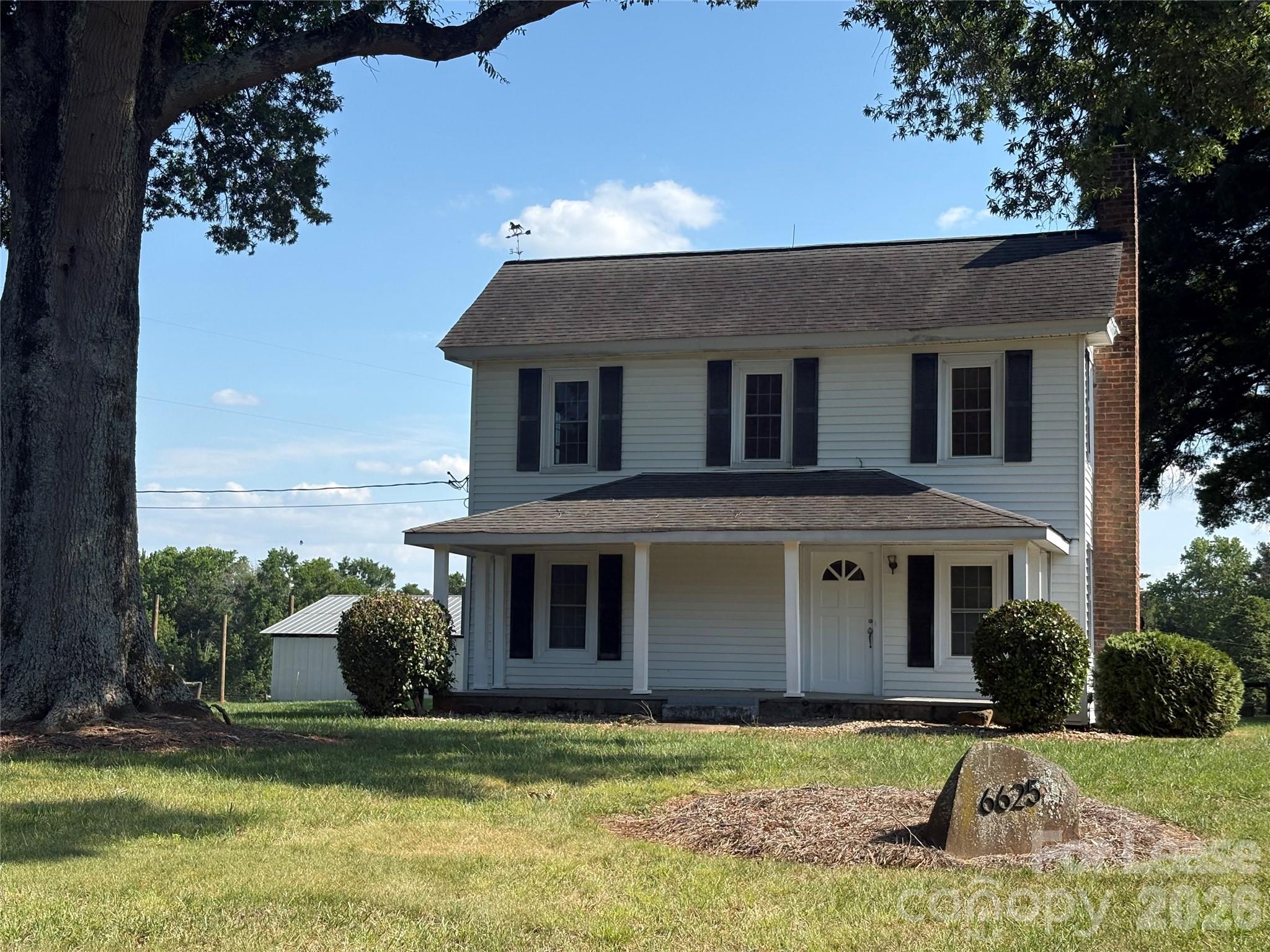 6625 Long Road Matthews, NC 28104 - Photo 2 of 21 a front view of a house with garden