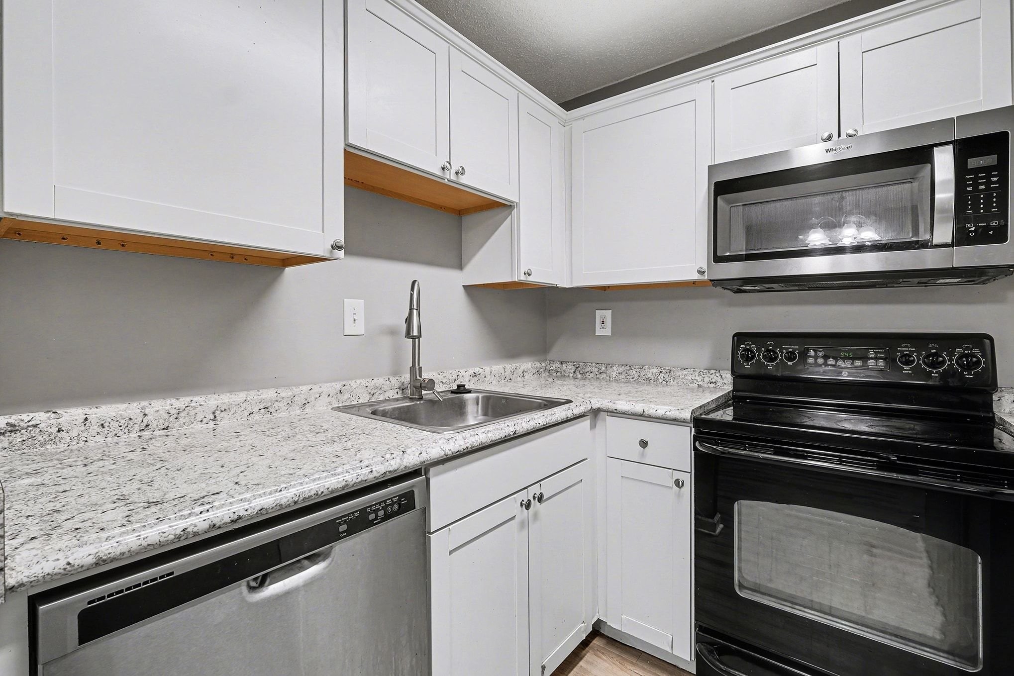 500 Paragon Mills Road, Unit N15 Nashville, TN 37211 - Photo 3 of 11 a kitchen with granite countertop cabinets stainless steel appliances and sink