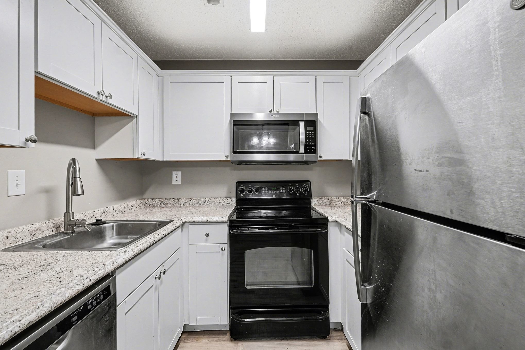 500 Paragon Mills Road, Unit N15 Nashville, TN 37211 - Photo 4 of 11 a kitchen with a stove microwave and refrigerator